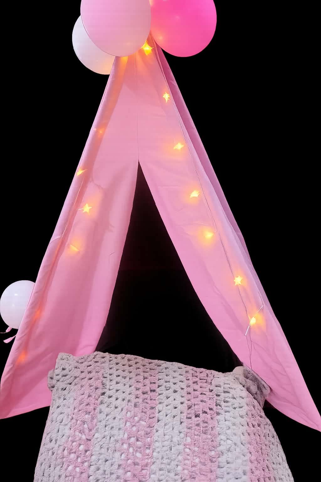 Pink indoor sleepover tent with lights and bedding